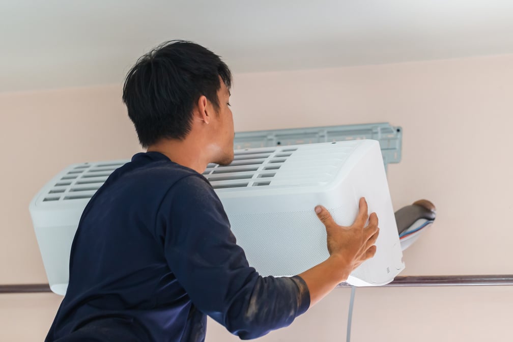 Air conditioning technicians install new air conditioners in homes, Repairman fix air conditioning systems, Male technician service for repair and maintenance of air conditioners